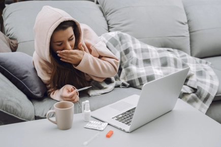 Sick woman with headache sitting home